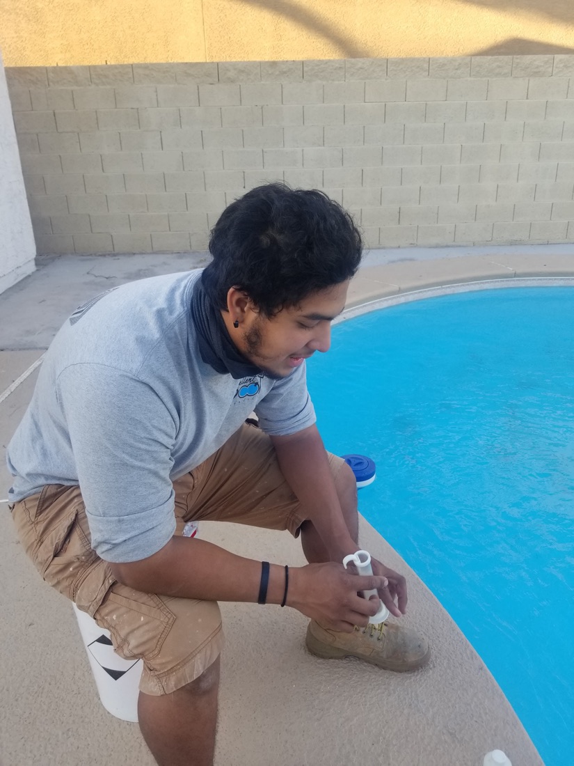 Excellent Pool Care technician testing pool water chemistry